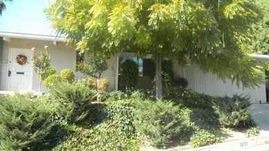 Front entrance, covered patio and two car garage.