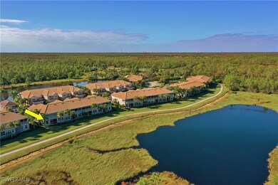 Birds eye view of property with a water view