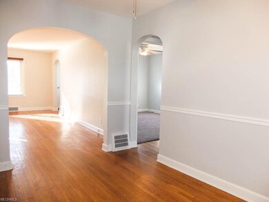 The dining room has an arched doorway to the livin