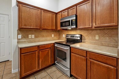 Kitchen with light tile patterned floors, decorati