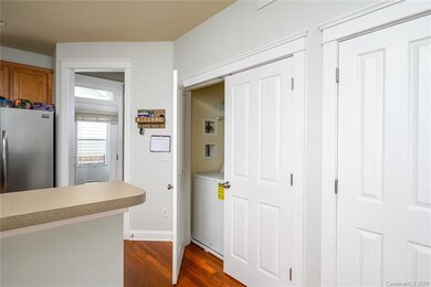 Laundry room conveniently located near kitchen w/dual door.  Washer & Dryer to remain.