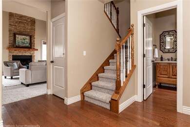 Formal entry with beautiful staircase, real wood floors, new carpet and powder room