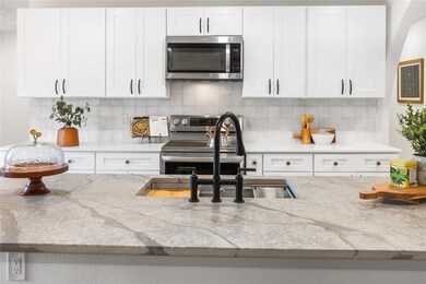 Kitchen with appliances with stainless steel finis