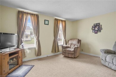 Sitting room with light carpet and a healthy amoun