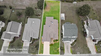 Aerial view of residential area featuring property boundaries highlighted