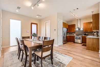 Dining space with rail lighting, light wood-style