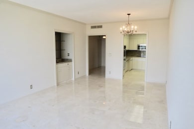 Open living and dining room space with beautiful marble floors