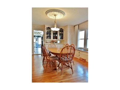 This large dining room offers wood flooring, a box window, an updated chandelier & provides access to the kitchen & great room.