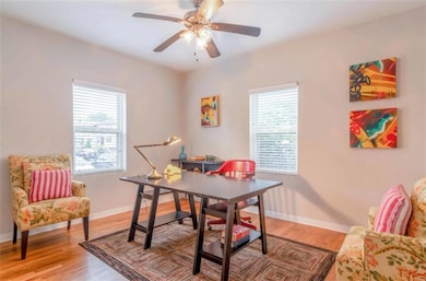 Dining room with wood-type flooring, plenty of nat