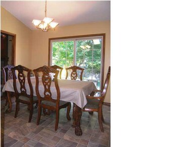 The spacious dining features an update chandelier.
