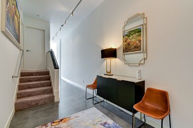 Spacious entryway with plenty of wall space for ar