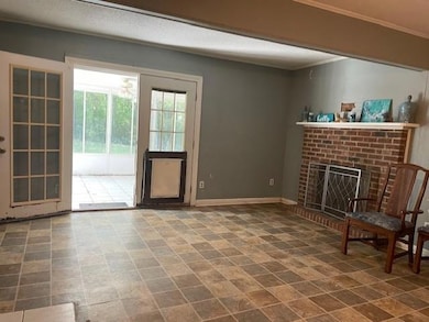 Unfurnished room featuring baseboards, a textured 