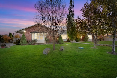View of front of home with a yard and brick siding