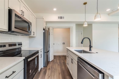 Kitchen with stainless steel appliances, a sink, 