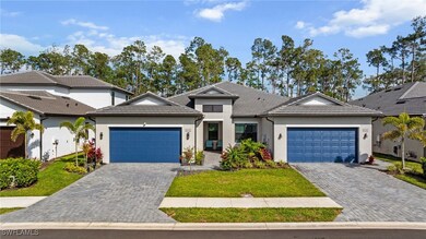 View of front of property featuring a garage, a ti