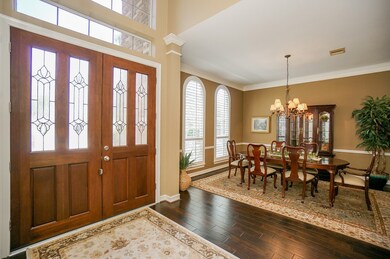 Lush double doors are works of art, in themselves! Your inside view begins with huge front formal rooms. A potential dining area is seen here. Big arched windows with plantation shutters bring pure natural light into this  generous space.