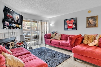 Living area with light tile patterned floors, a fi