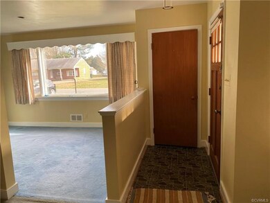 Sunny dining room/flex room.  Hardwood under all the carpet and rugs.
