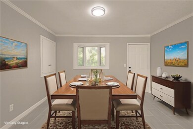 Dining area featuring crown molding and baseboards