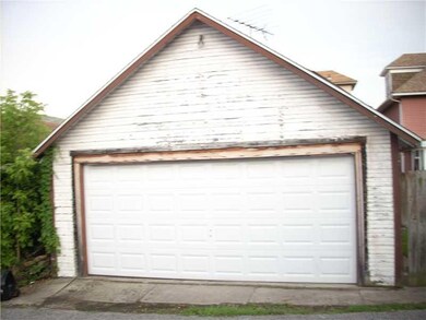 Exterior Back. Detached garage, small fenced yard