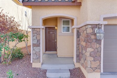 Entrance to property with stone siding and stucco