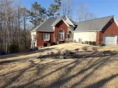 View of front of house with brick siding, driveway
