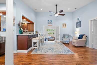 Living room with wood-type flooring and ceiling fa