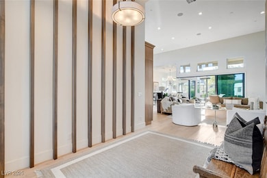 Entry featuring a towering ceiling, wood finished