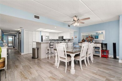 Dining space featuring ceiling fan, a textured ceiling, and light wood-style floors
