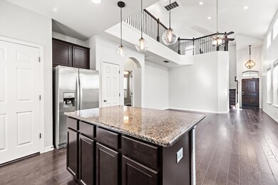 Kitchen featuring dark brown cabinets, dark wood 