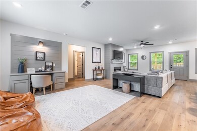 Split floorplan has the secondary bedrooms and bathroom off the hallway behind the living room.