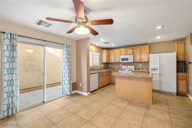 Kitchen with visible vents, a sink, a ceiling fan,