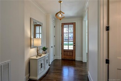 Welcoming foyer with beautiful hardwoods and custo