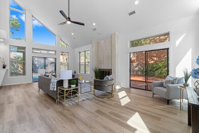 The large living room has walls of windows and a g
