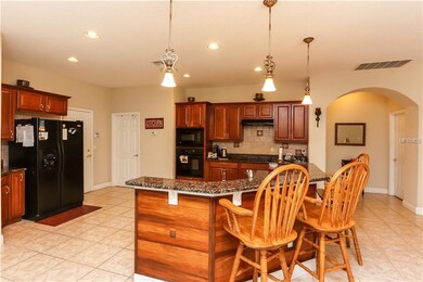 Huge kitchen features granite counter-tops and ple