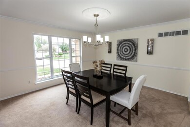 Dining room with updated lighting, chair railing and interior has been professionally painted.