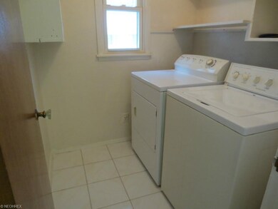 First floor laundry room with ceramic tile floor; 