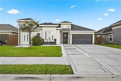 Prairie-style house featuring stucco siding, concrete driveway, an attached garage, and roof with shingles