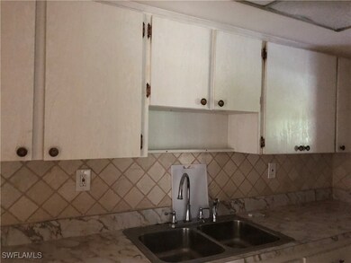 Kitchen featuring white cabinetry, sink, and taste
