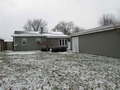 Back yard showing large, over-sized one car garage