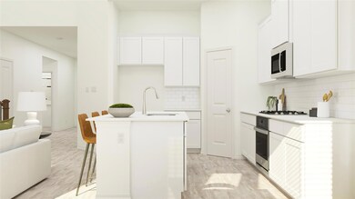 Kitchen with light countertops, an island with sin