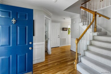 Entrance foyer featuring crown molding and light h