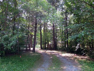 Exterior Front. 4.8 acres, private, wooded setting