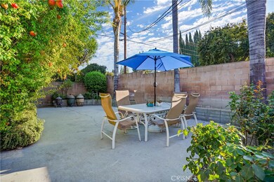 Backyard dining area, pomegranate trees