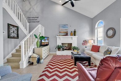 Tiled living room featuring ceiling fan, high vaul