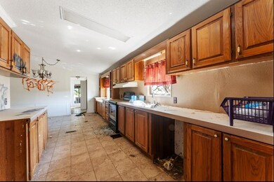Kitchen featuring a textured ceiling, lofted ceili