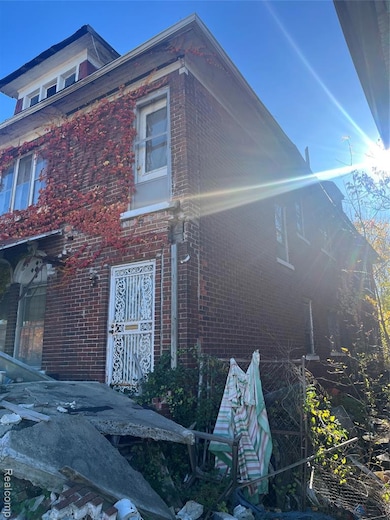View of side of home featuring brick siding