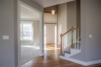 Light & bright TWO-STORY ENTRY featuring hardwood 