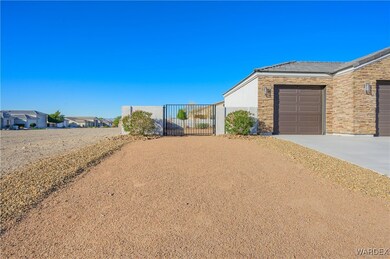 View of front of house with stone siding, driveway