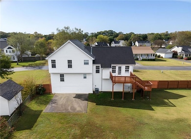 Rear view of property with a fenced backyard, stairs, a residential view, and a wooden deck